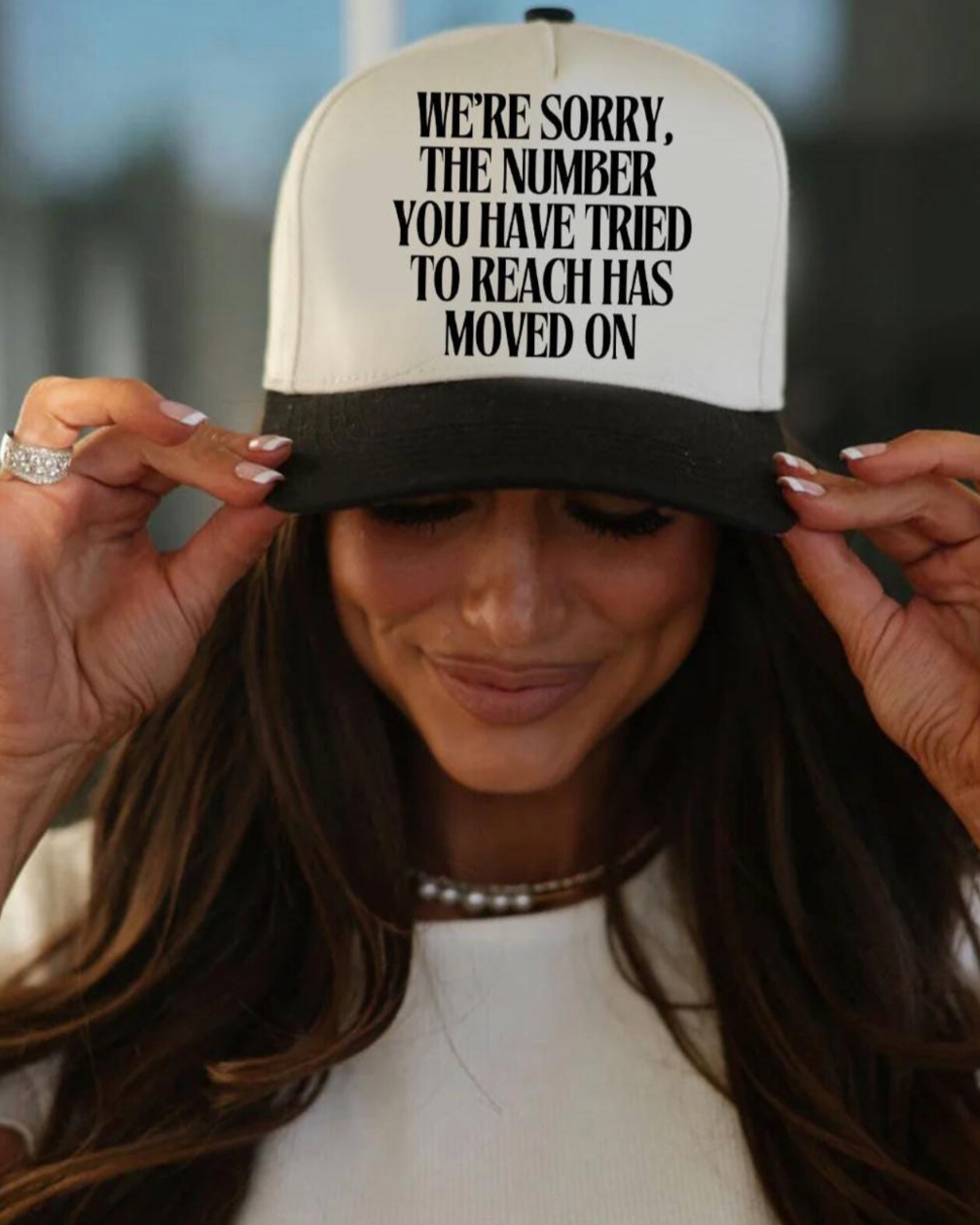 Person wearing a cap with humorous text message