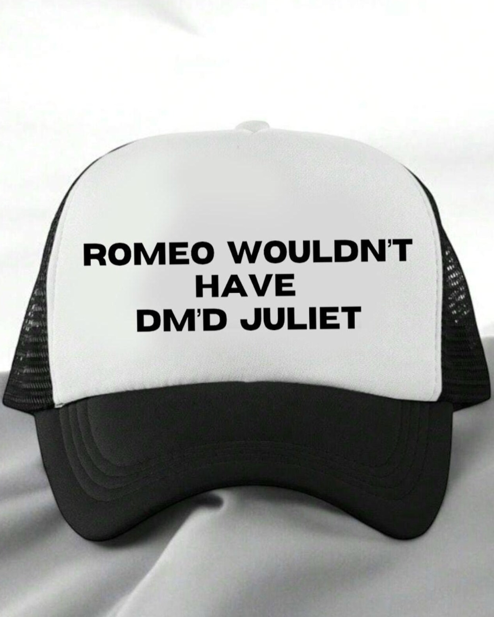 Black and white cap with text 'ROMEO WOULDN'T HAVE DM'D JULIET' on a white background