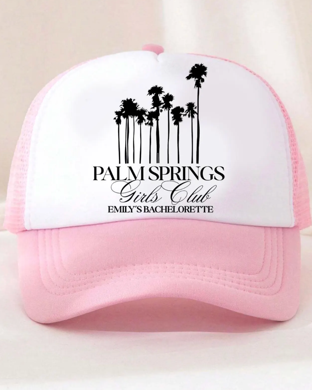 Pink cap with 'Palm Springs Girls Club' design on a white background