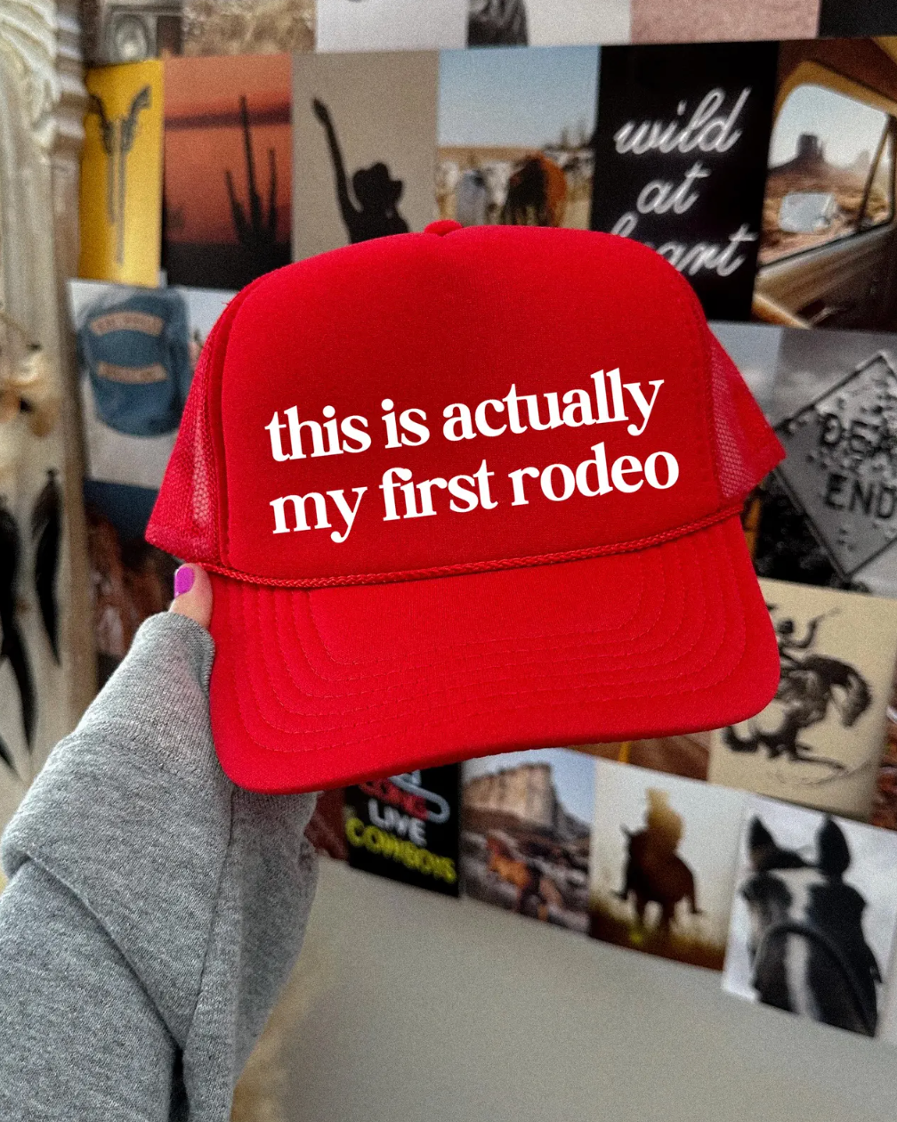 Red cap with 'this is actually my first rodeo' text held in front of a collage of images.