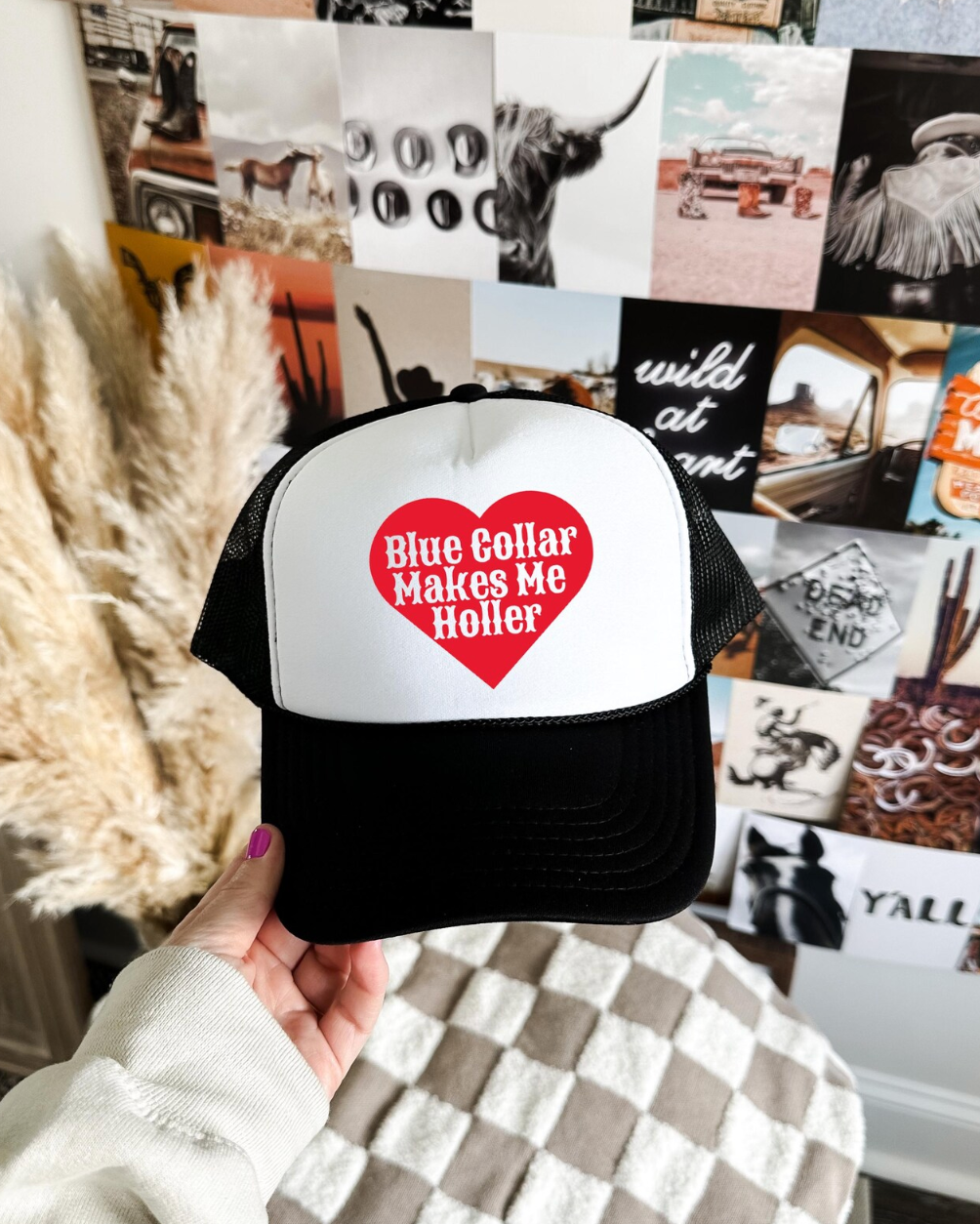 Trucker hat with 'Blue Collar Makes Me Holler' design held in front of a collage of photos.