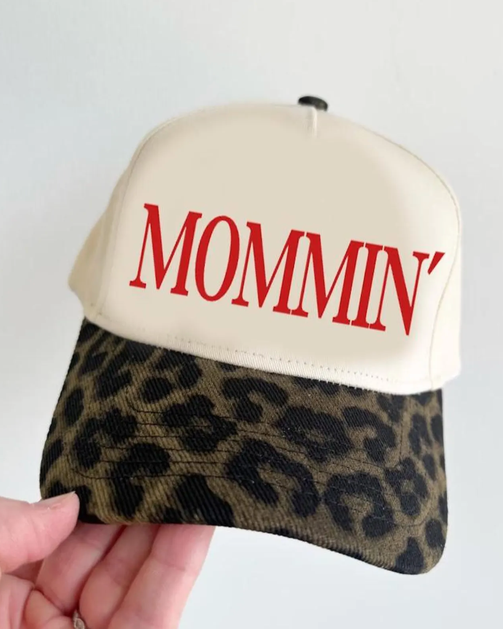 Cap with 'MOMMIN' text on a white background