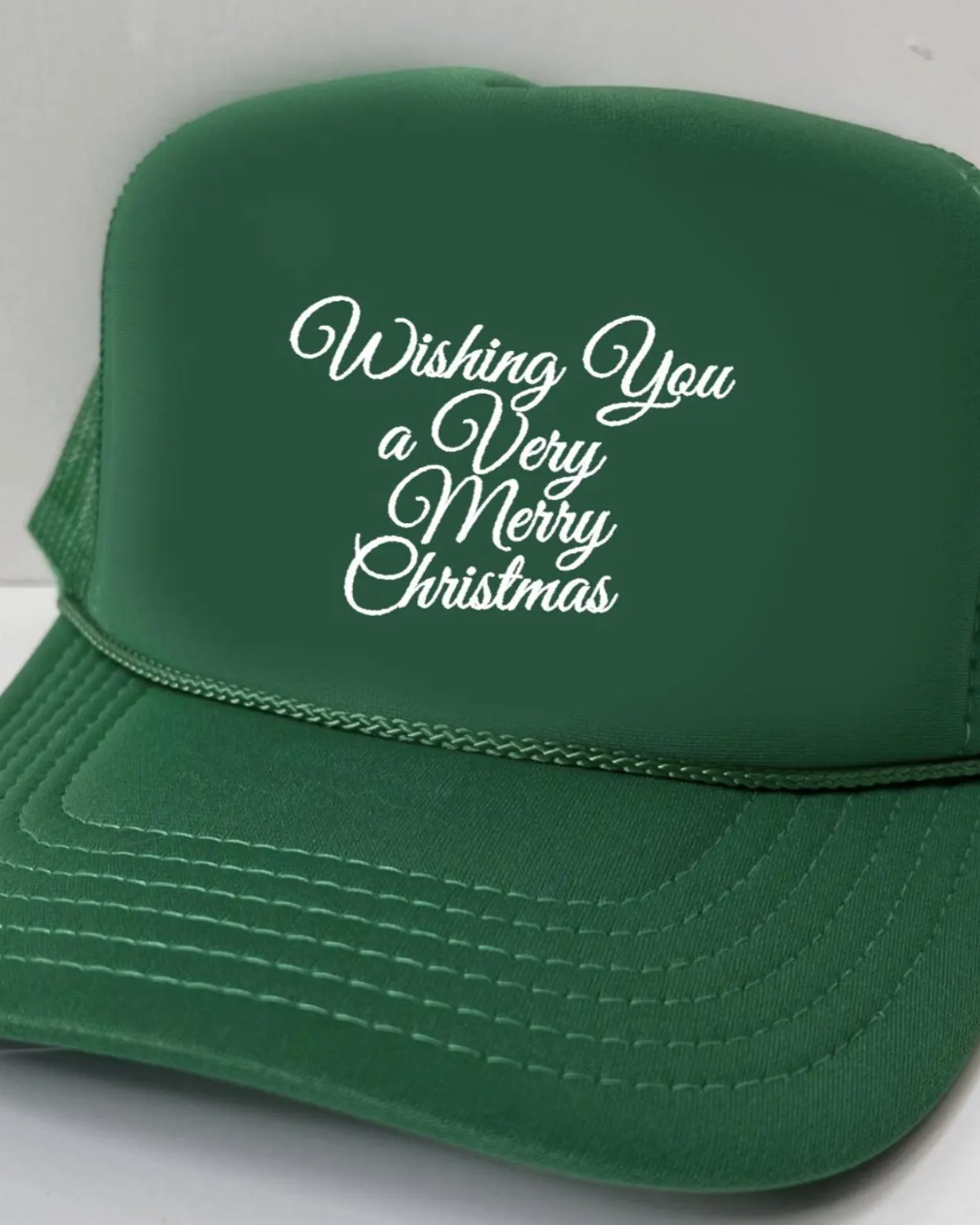 Green cap with 'Wishing You a Very Merry Christmas' text on a white background