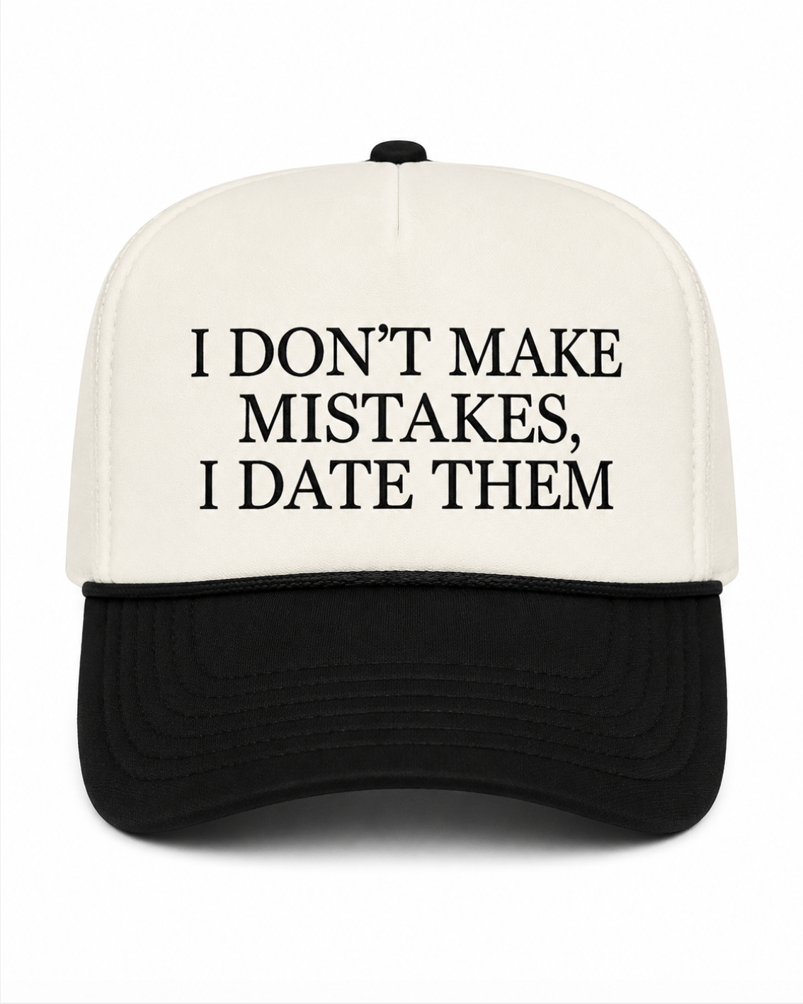 A black and white trucker-style cap with the text 'I DON'T MAKE MISTAKES, I DATE THEM' printed in black on the white front panel, shown against a plain white background.